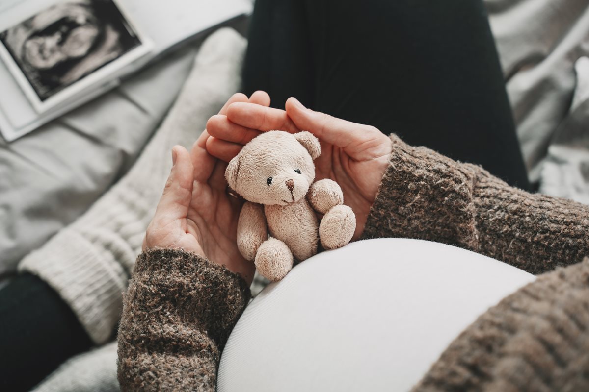 Pregnant Woman with Bear in Hand